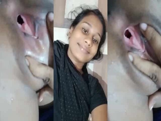 A mischievous woman displays her unclothed genitalia on camera in a bathroom